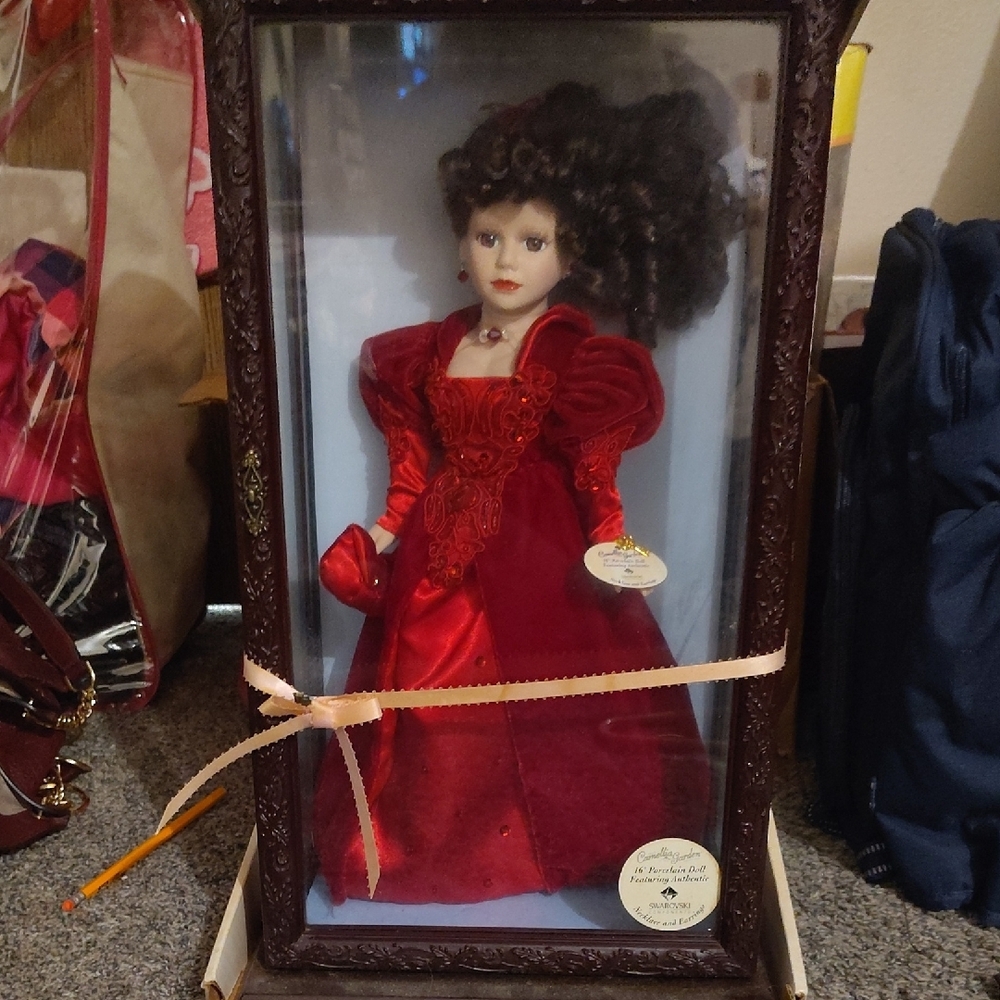 Elegant Red Porcelain Doll in Display Case